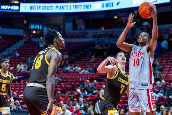 UNLV guard Jaden Henley (10) gets inside of Wyoming Cowboys forward Matija Belic (7) for a bask ...