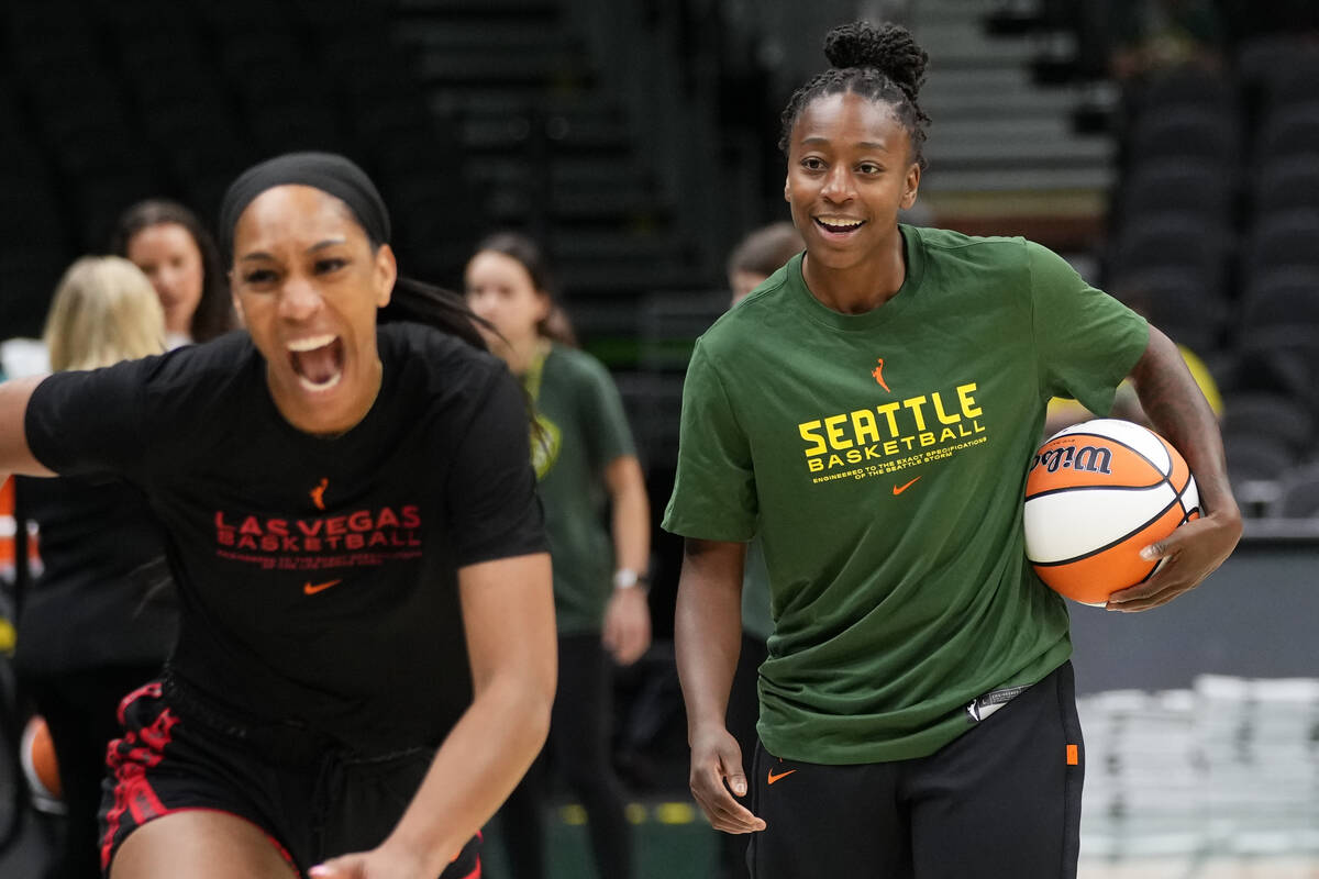 Las Vegas Aces forward A'ja Wilson, left, runs away smiling after talking with Seattle Storm gu ...