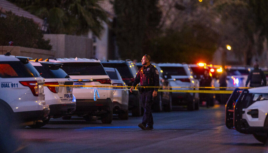 Personnel work the scene of a North Las Vegas Police officer-involved shooting along the 4700 b ...