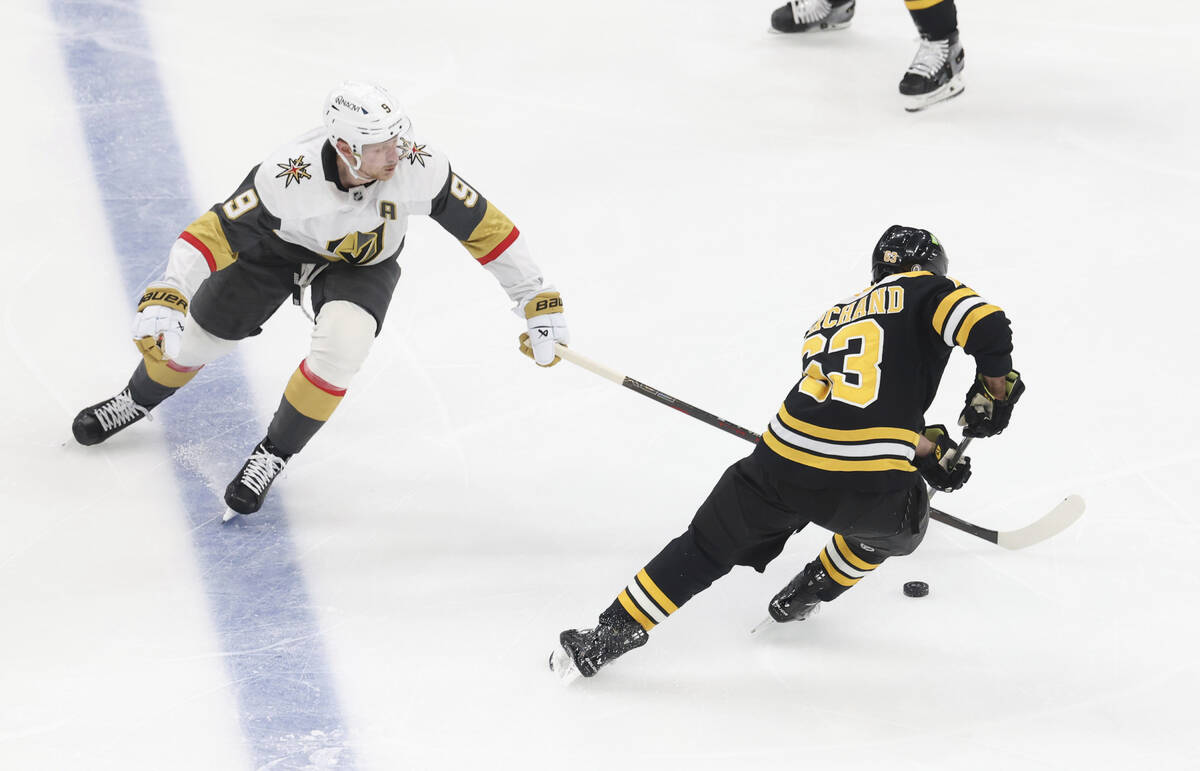 Vegas Golden Knights center Jack Eichel (9) and Boston Bruins left wing Brad Marchand (63) chas ...