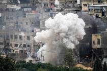 Israeli soldiers detonate an explosive device during a military raid in the West Bank refugee c ...