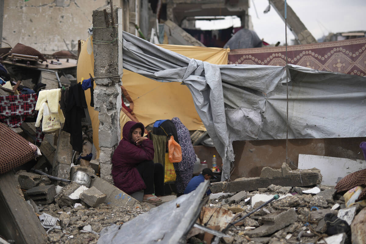 The Rehan family in their encampment in the ruins of their home amid widespread destruction cau ...