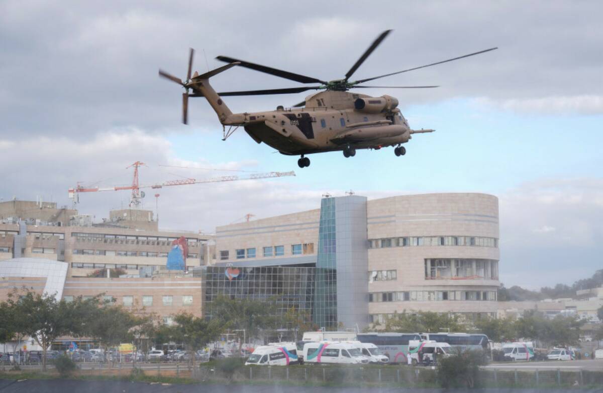 An Israeli military helicopter carrying Israel hostages arrives at the Sheba Hospital in Ramat ...