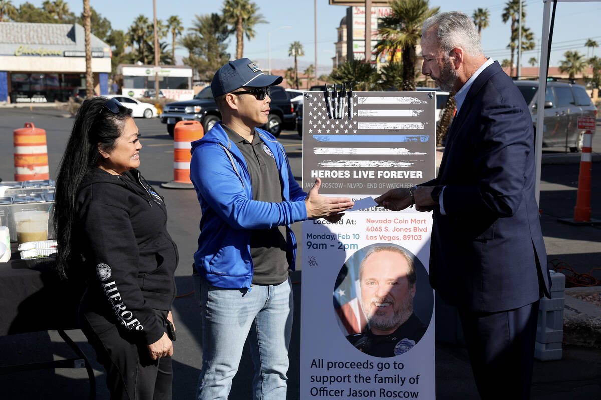 Injured Police Officers Fund Vice President and Las Vegas police Sgt. Charles Jivapong, center, ...