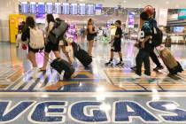 Arriving passengers head to baggage claim area at Terminal 1 of Harry Reid International Airpor ...