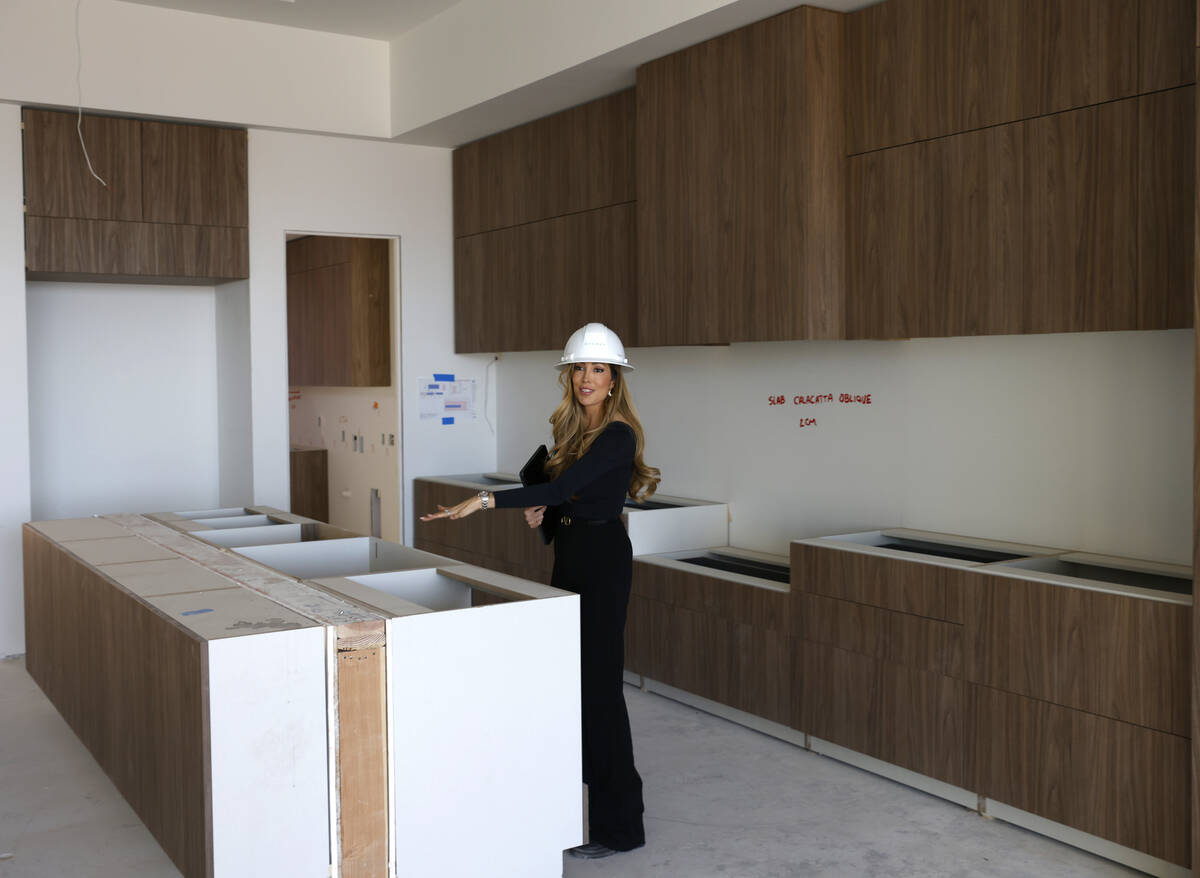 Melissa Tomastik, director of sales at Ascaya, leads a tour of one of horizontal condos under c ...