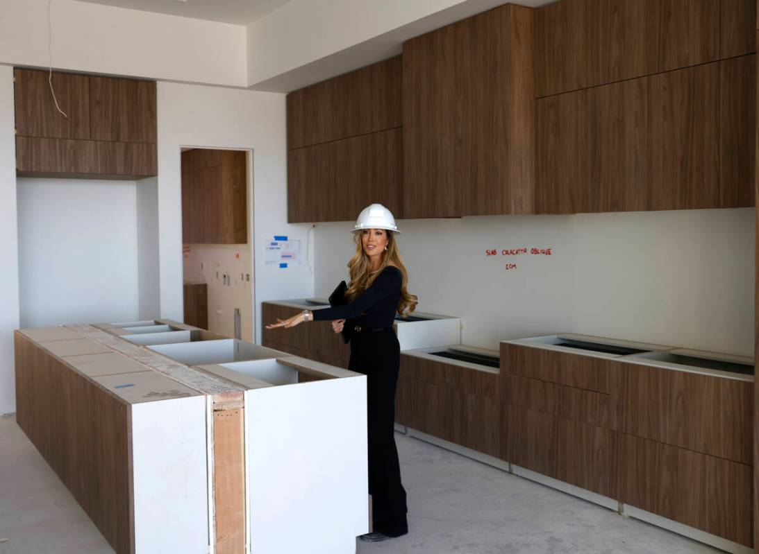 Melissa Tomastik, director of sales at Ascaya, leads a tour of one of horizontal condos under c ...