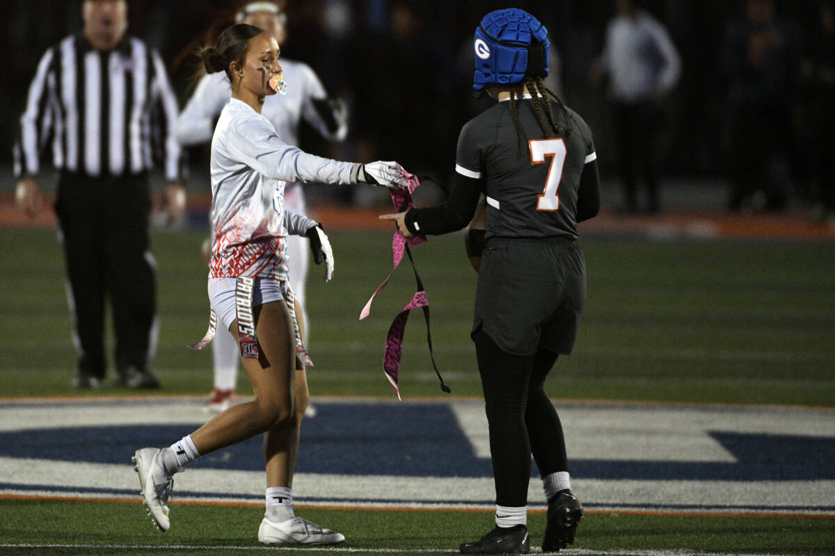 Liberty linebacker Jaidah Griego hands back Bishop Gorman Avery Reed’s belt during the 5 ...
