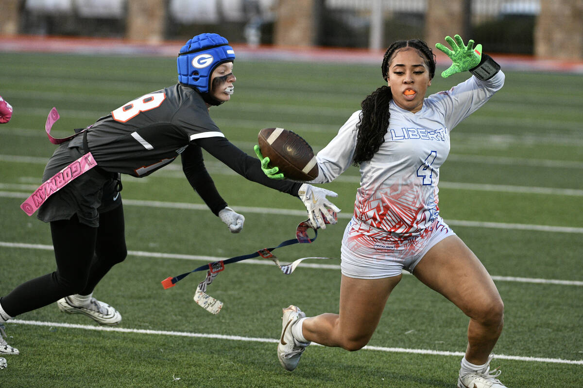 Liberty wide receiver Ki'lolo Westerlund is tackled by Bishop Gorman’s Grace Yager during the ...