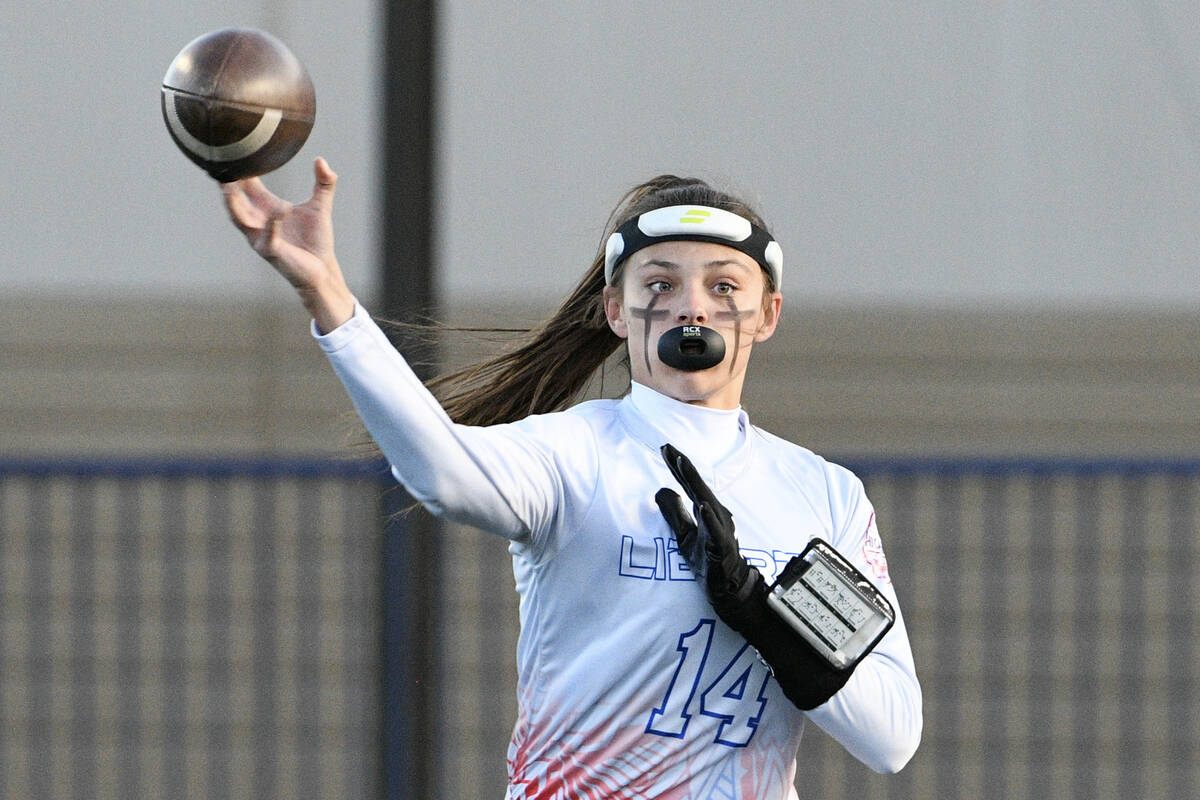 Liberty quarterback Kaylie Phillips throws during the 5A flag football state quarterfinals agai ...