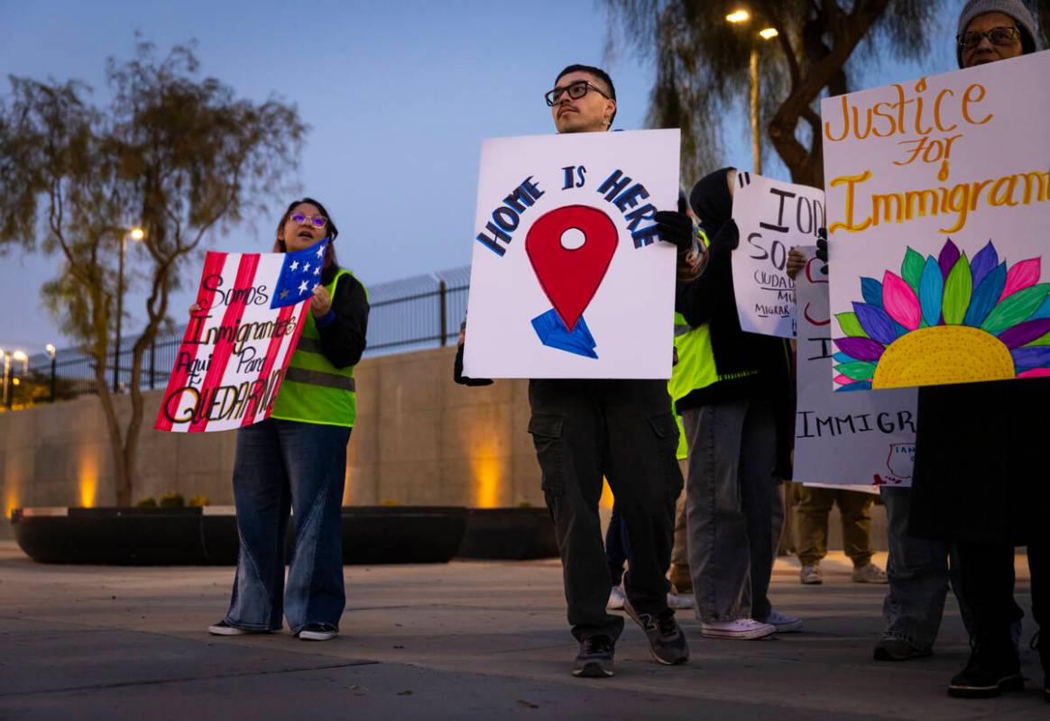 Make the Road Nevada political organizer Marco R. Holds up a sign during a rally against newly ...