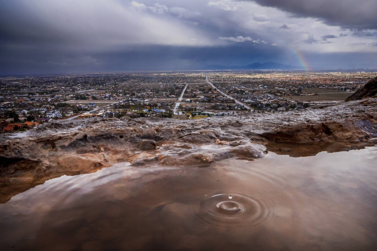 A raindrop falls into a puddle on Lone Mountain as rain scatters over the Las Vegas Valley on F ...