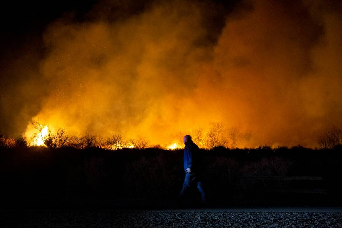 Law enforcement roams the perimeter of a brush fire burning at Clark County Wetlands Park on Fe ...