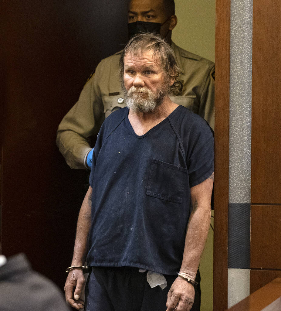 Freddy Allen, accused of fatally stabbing a police officer on the Strip, lead into the courtroo ...