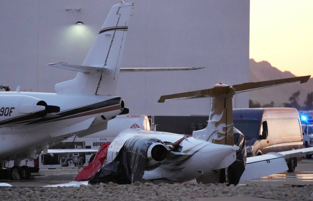 A crashed Learjet, right, sits damaged after colliding with another plane at Scottsdale Airport ...