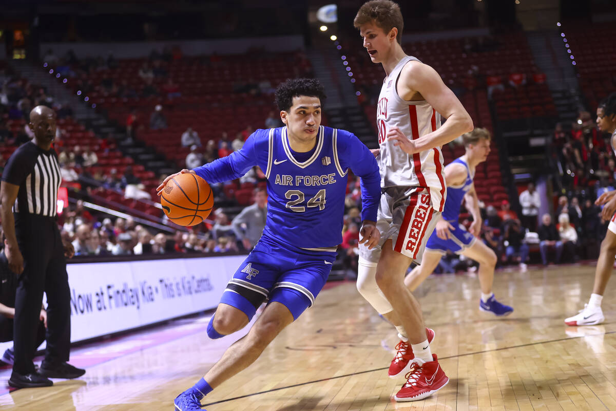 Air Force guard Jeffrey Mills (24) drives to the basket around UNLV guard Julian Rishwain (20) ...