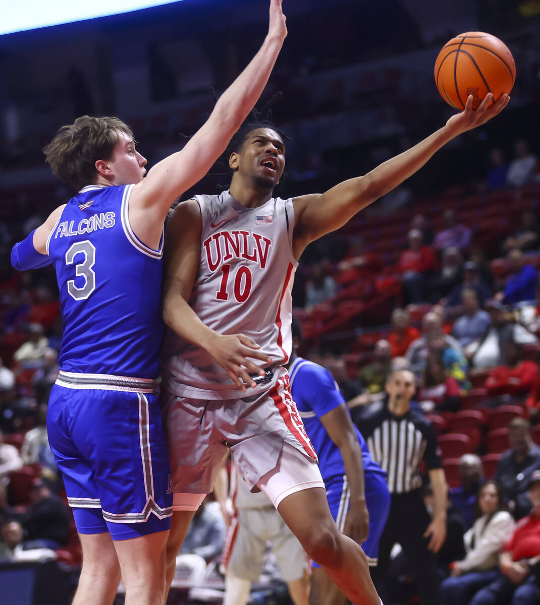 UNLV guard Jaden Henley (10) lays up the ball against Air Force forward Luke Kearney (3) during ...