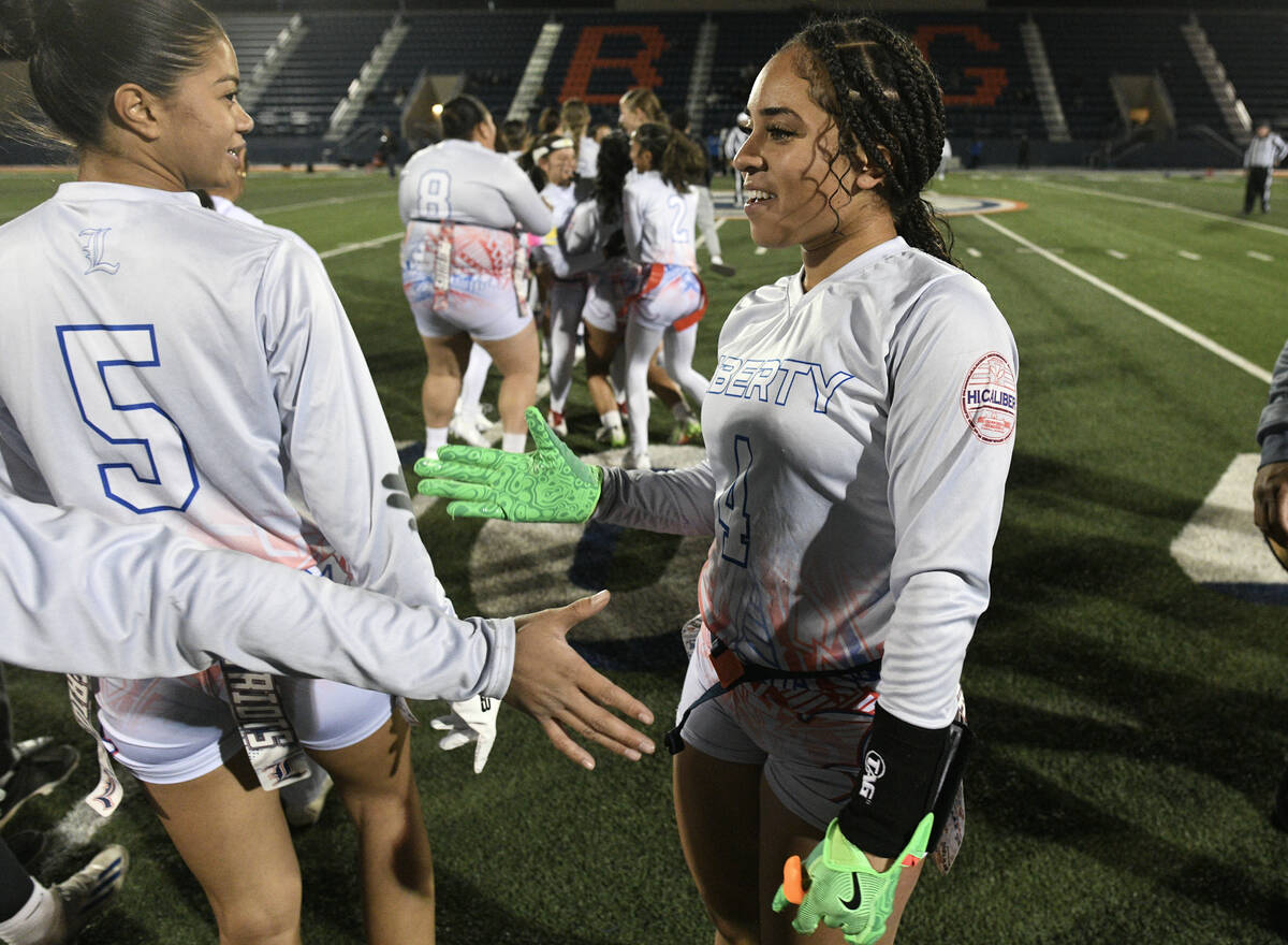 Liberty’s Kilolo Westerlund is greeted by teammates after their 5A flag football state q ...