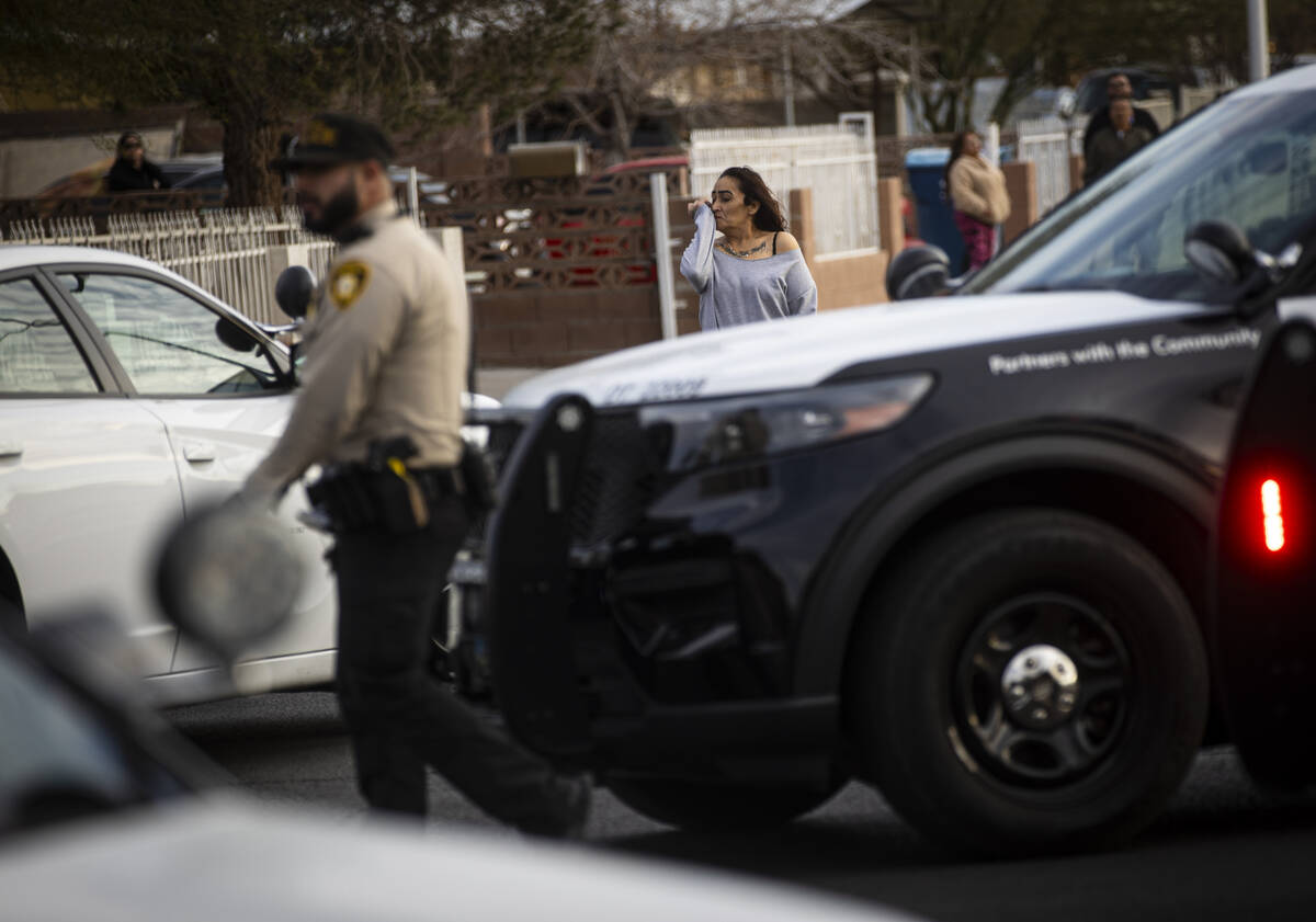 A woman reacts as Las Vegas police and firefighters respond to the scene of an unconscious man ...