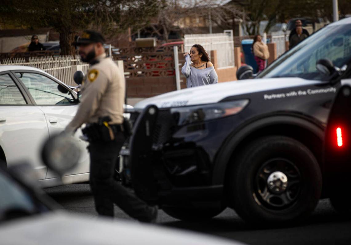 A woman reacts as Las Vegas police and firefighters respond to the scene of an unconscious man ...