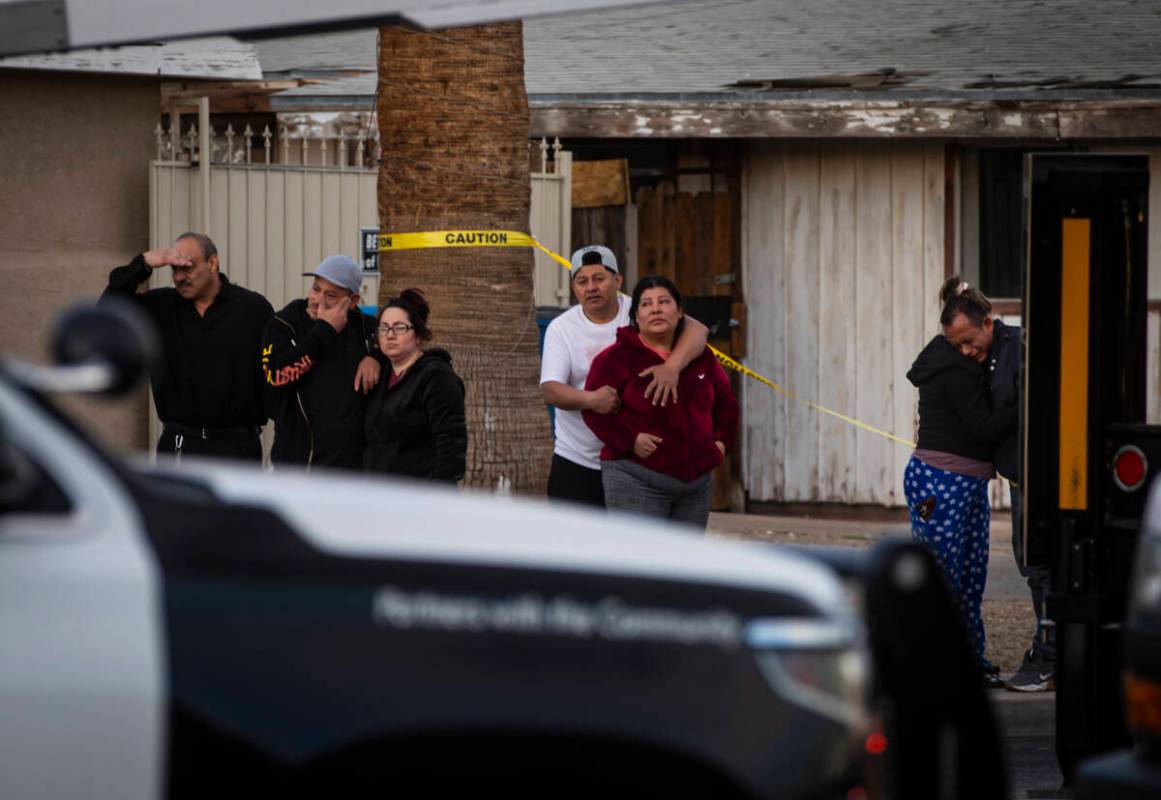People react before talking with Las Vegas police and viewing the body of the man who died, who ...