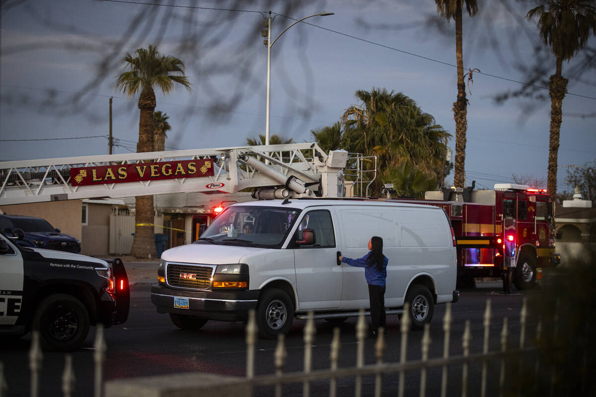 Employees of Davis Funeral Home prepare to transport the body of a man who died after getting s ...