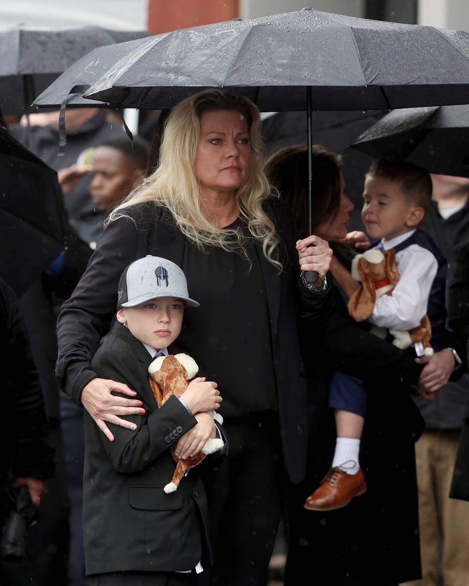 Officers and family members walk into the church during the celebration of life service for fal ...