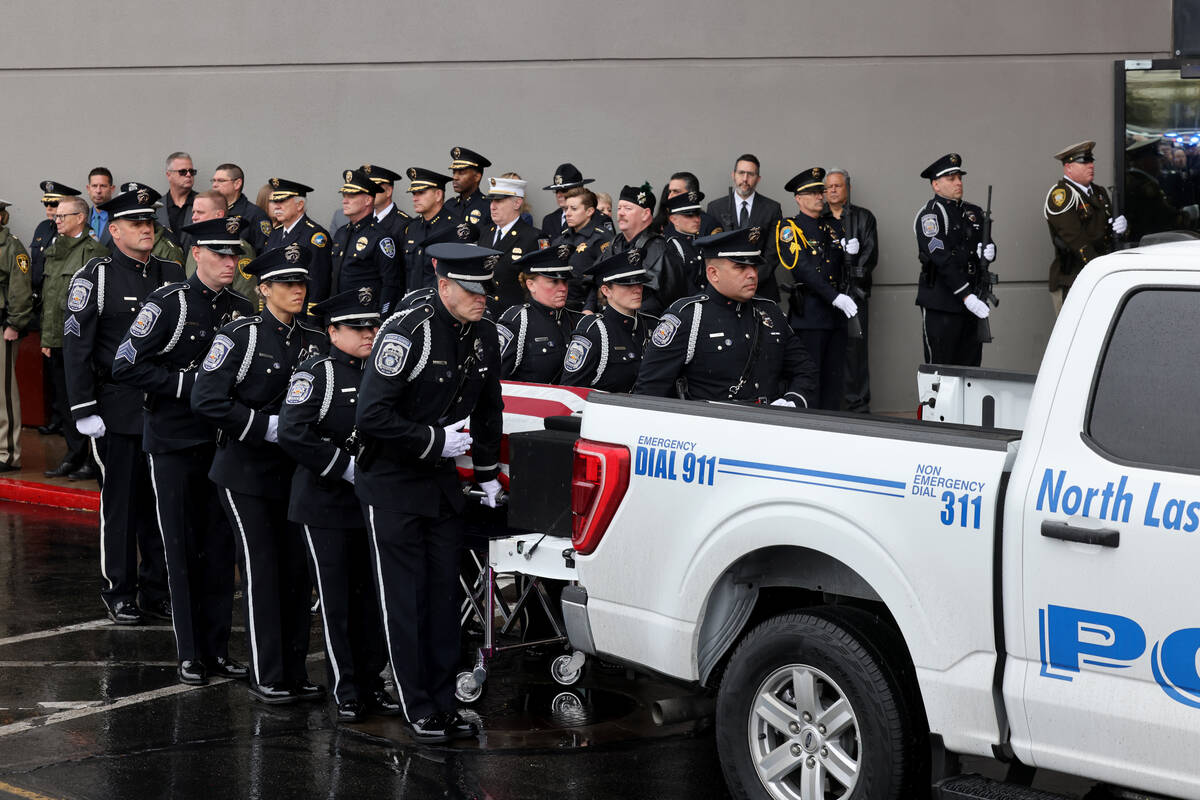 A North Las Vegas police honor guard loads the casket in the procession during the celebration ...