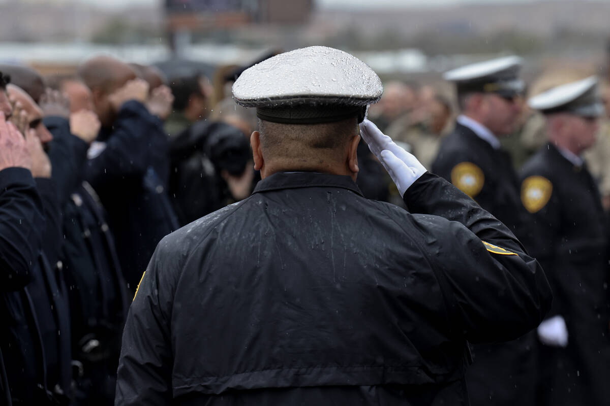 Law enforcement officers salute the procession during the celebration of life service for falle ...