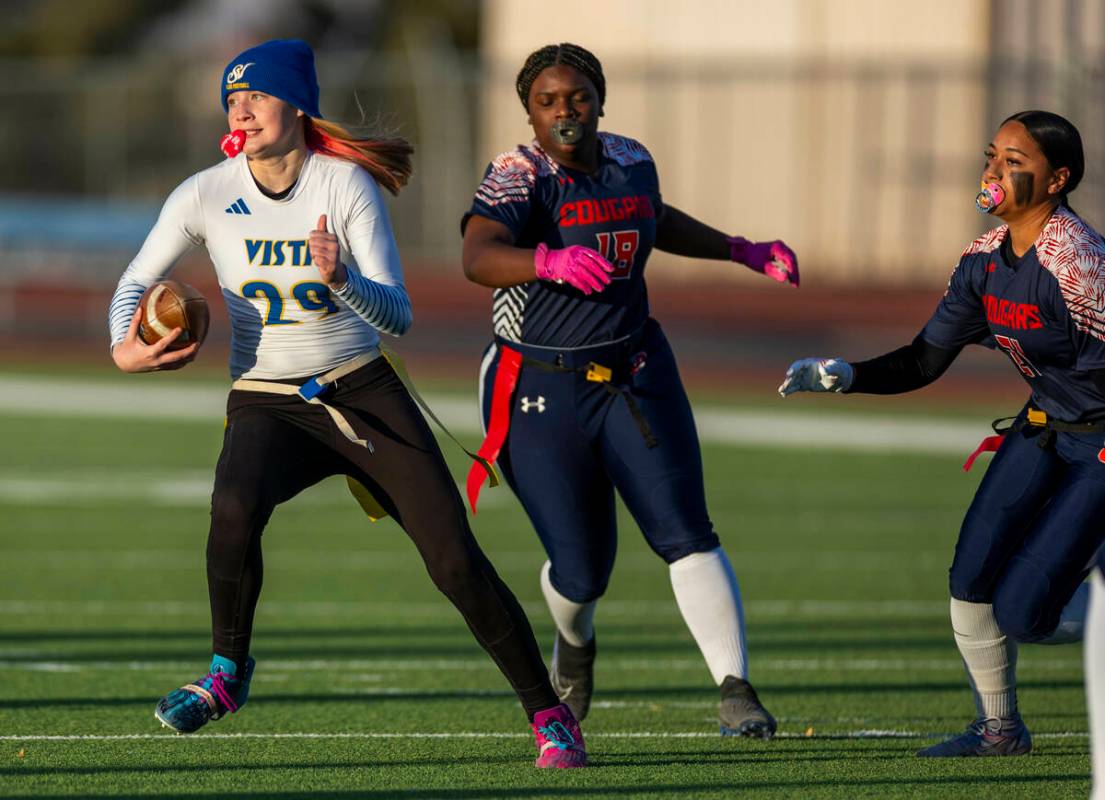 Sierra Vista quarterback Amaya Wusstig (29) evades Coronado linebacker Tielua Baptista (21) and ...