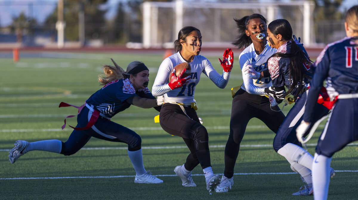 Sierra Vista runner Mary Agnes Kahawaii Pula (20) is caught from behind by Coronado linebacker ...
