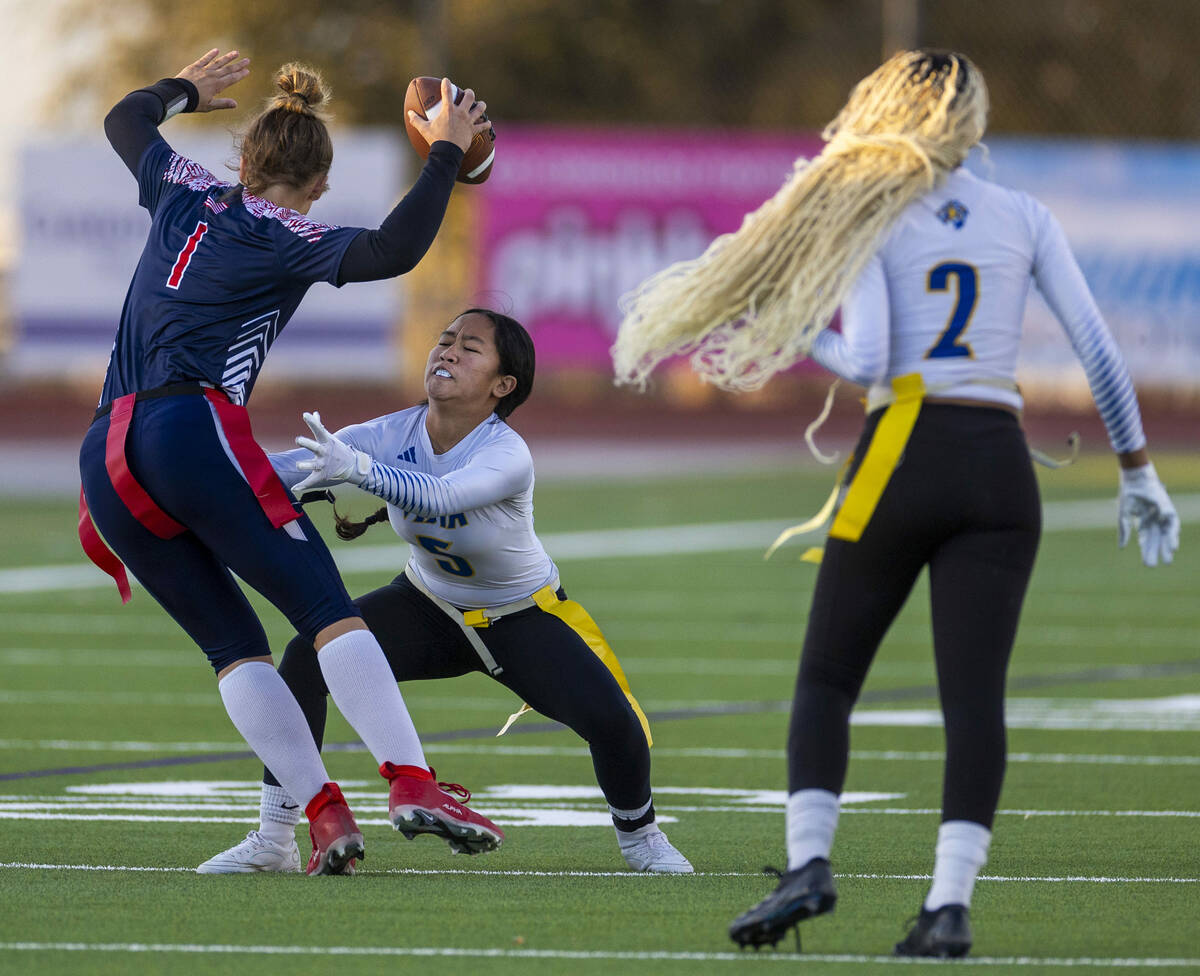 Coronado quarterback Bailey Goldberg (1) looks to evade a stop by Sierra Vista defender Amaya A ...