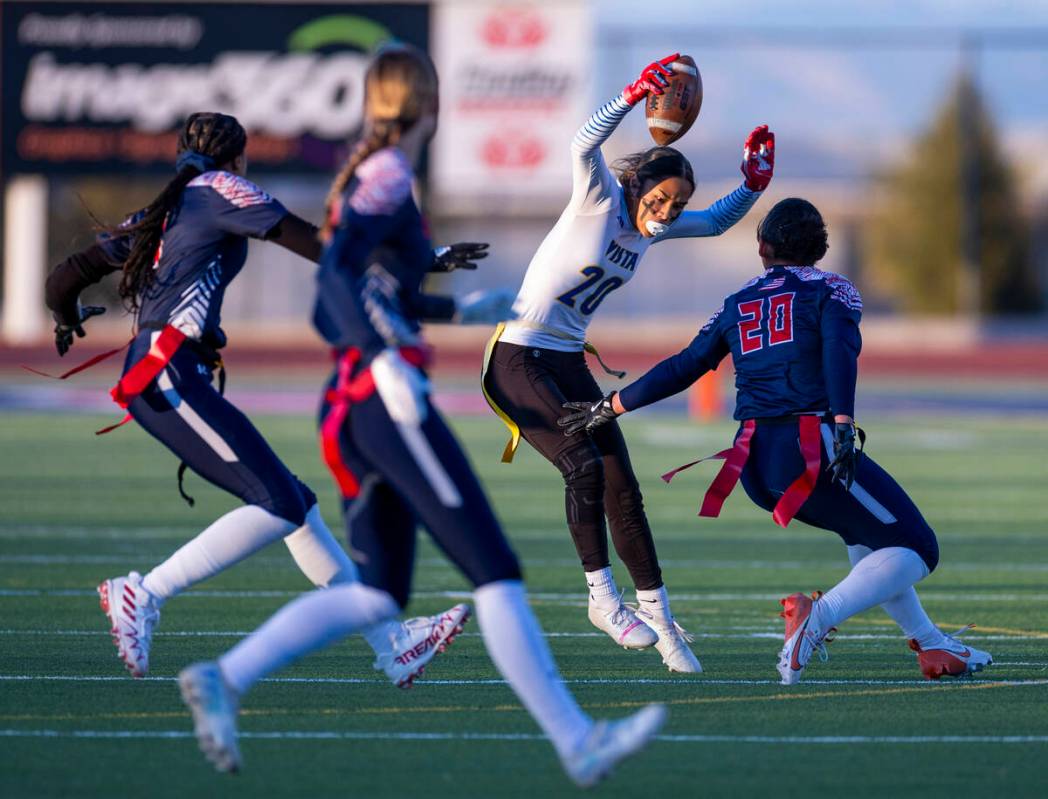 Sierra Vista runner Mary Agnes Kahawaii Pula (20) looks to evade a stop by linebacker Samia Lin ...