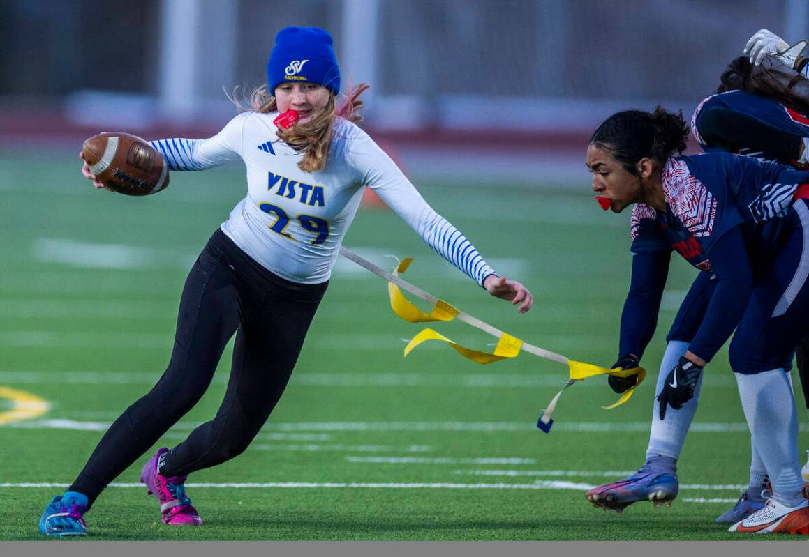 Sierra Vista quarterback Amaya Wusstig (29) has her flag pulled by Coronado linebacker Samia Li ...