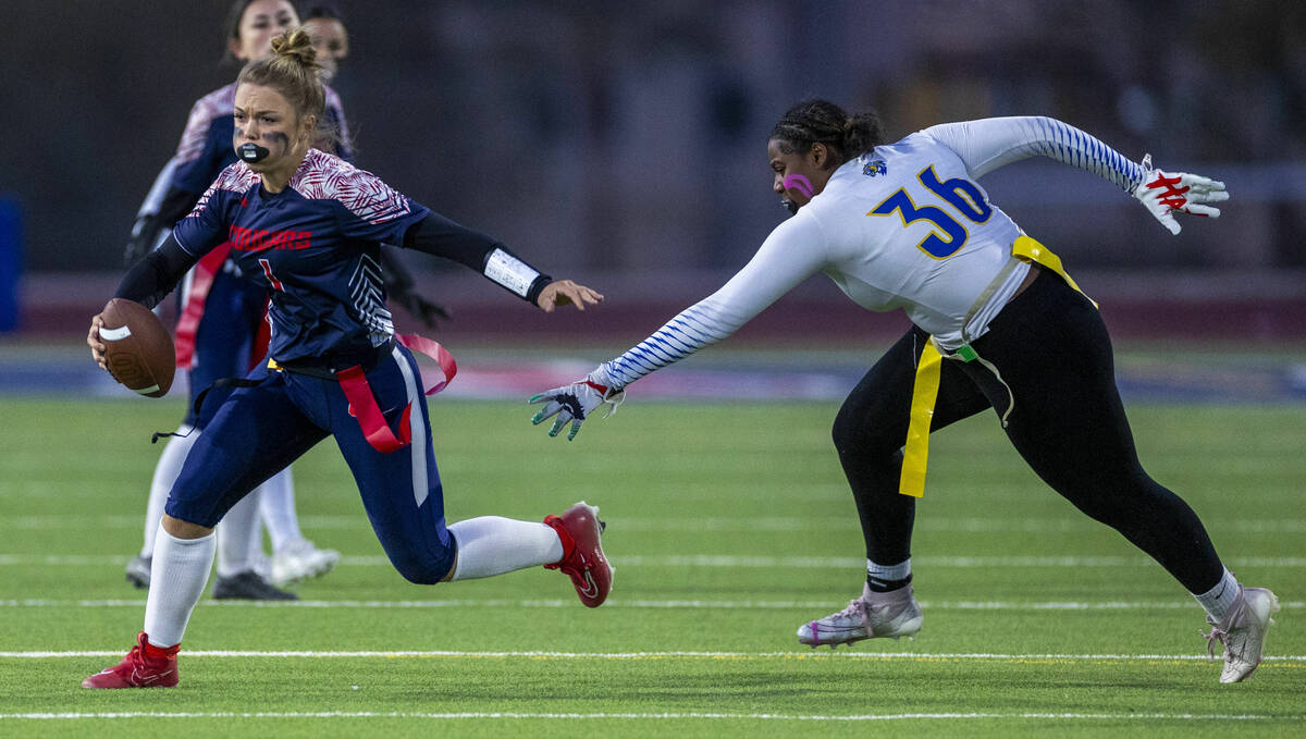 Coronado quarterback Bailey Goldberg (1) turns the corner on a run past Sierra Vista defender A ...