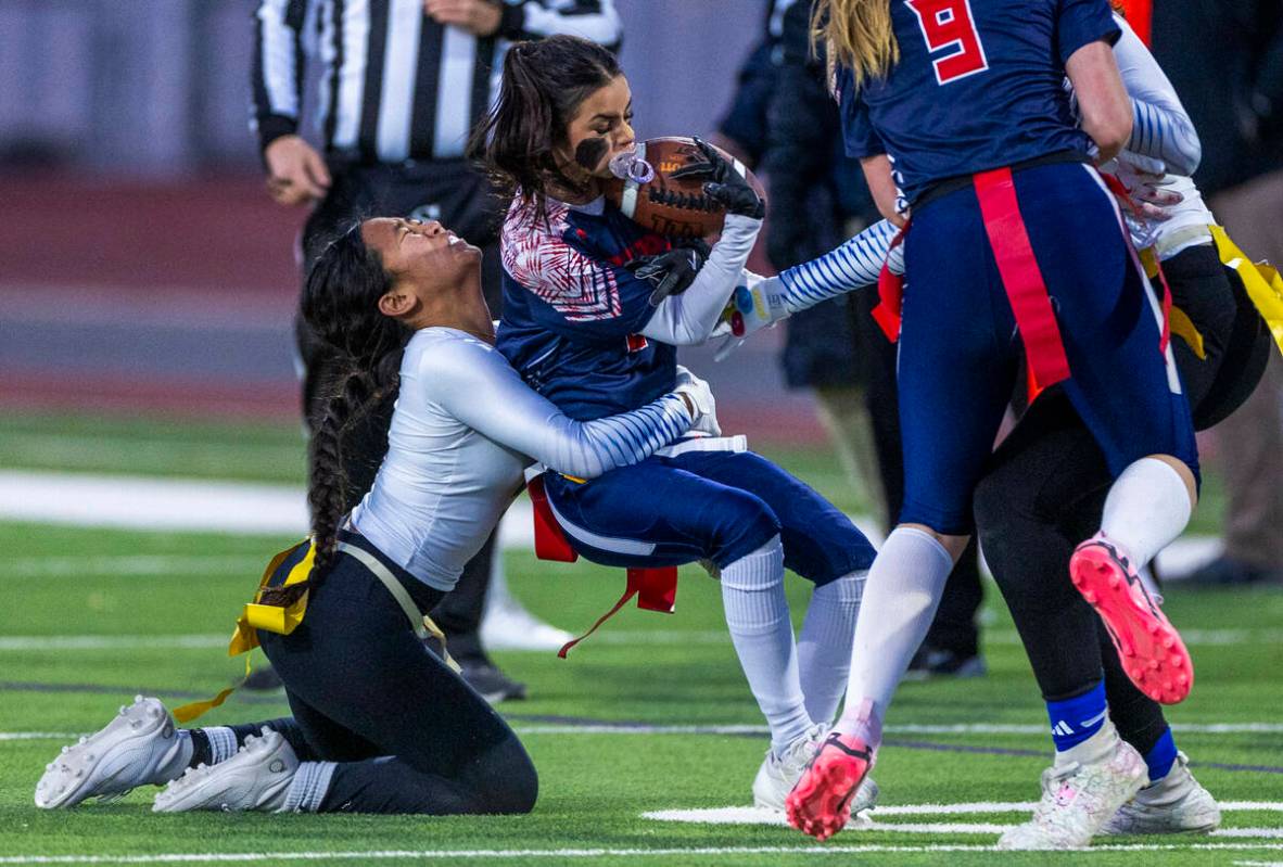 Coronado running back Maddy Aguilar (2) is wrapped up by Sierra Vista defender Amaya Acosta (5) ...