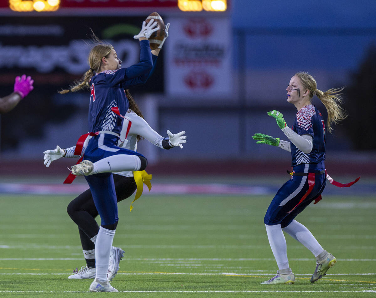 Coronado defensive back Lauren Wood (14) secures an interception over a Sierra Vista receiver d ...