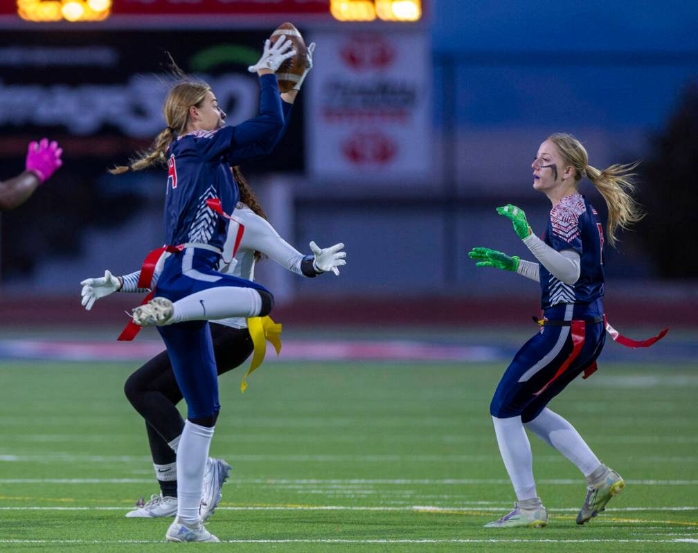 Coronado defensive back Lauren Wood (14) secures an interception over a Sierra Vista receiver d ...
