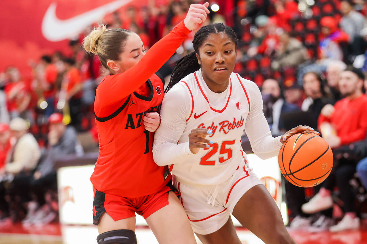 Lady Rebels guard Aaliyah Alexander (25) drivers the ball through defense by San Diego State Az ...