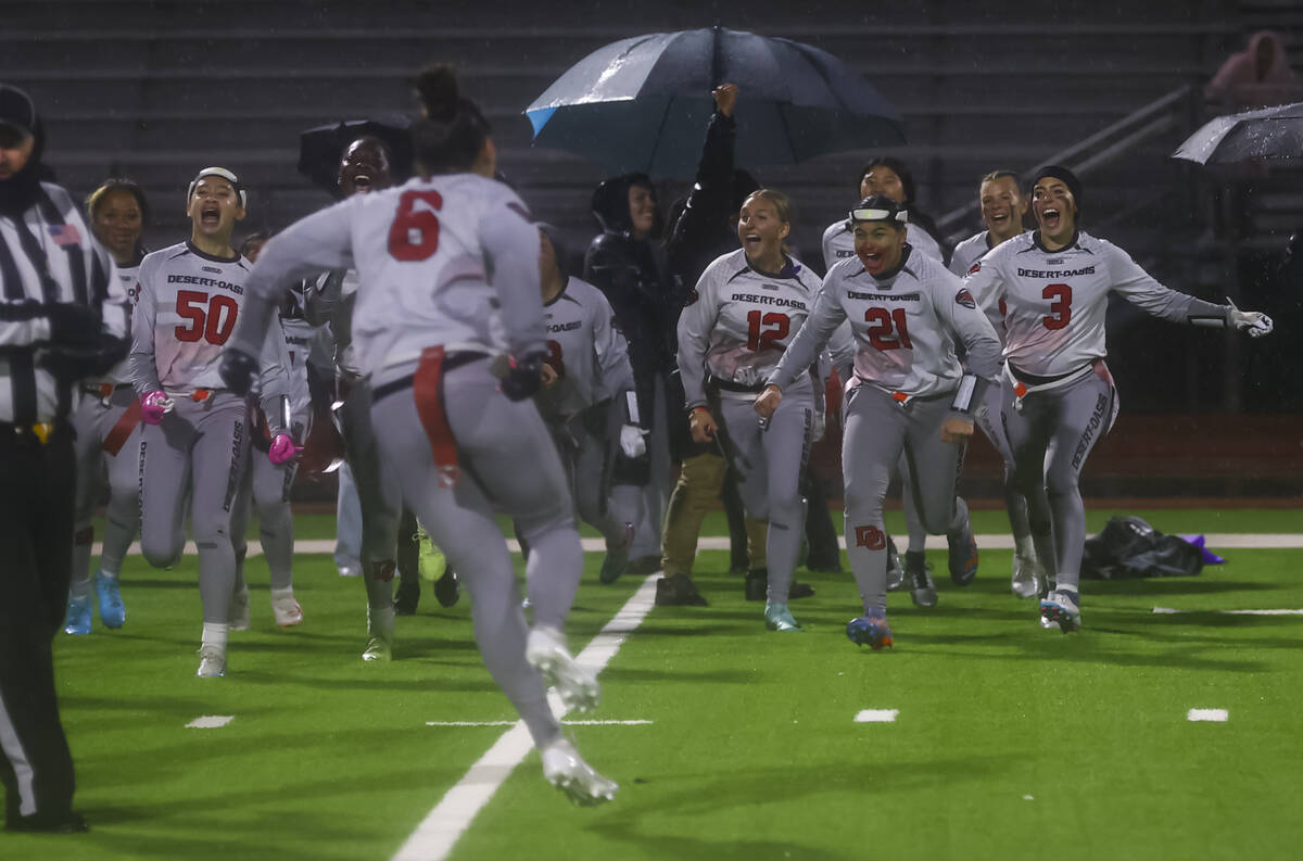 Desert Oasis players celebrate their victory over Shadow Ridge's in a 5A state semifinal flag f ...