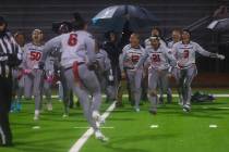 Desert Oasis players celebrate their victory over Shadow Ridge's in a 5A state semifinal flag f ...