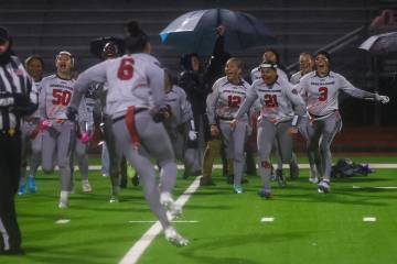 Desert Oasis players celebrate their victory over Shadow Ridge's in a 5A state semifinal flag f ...