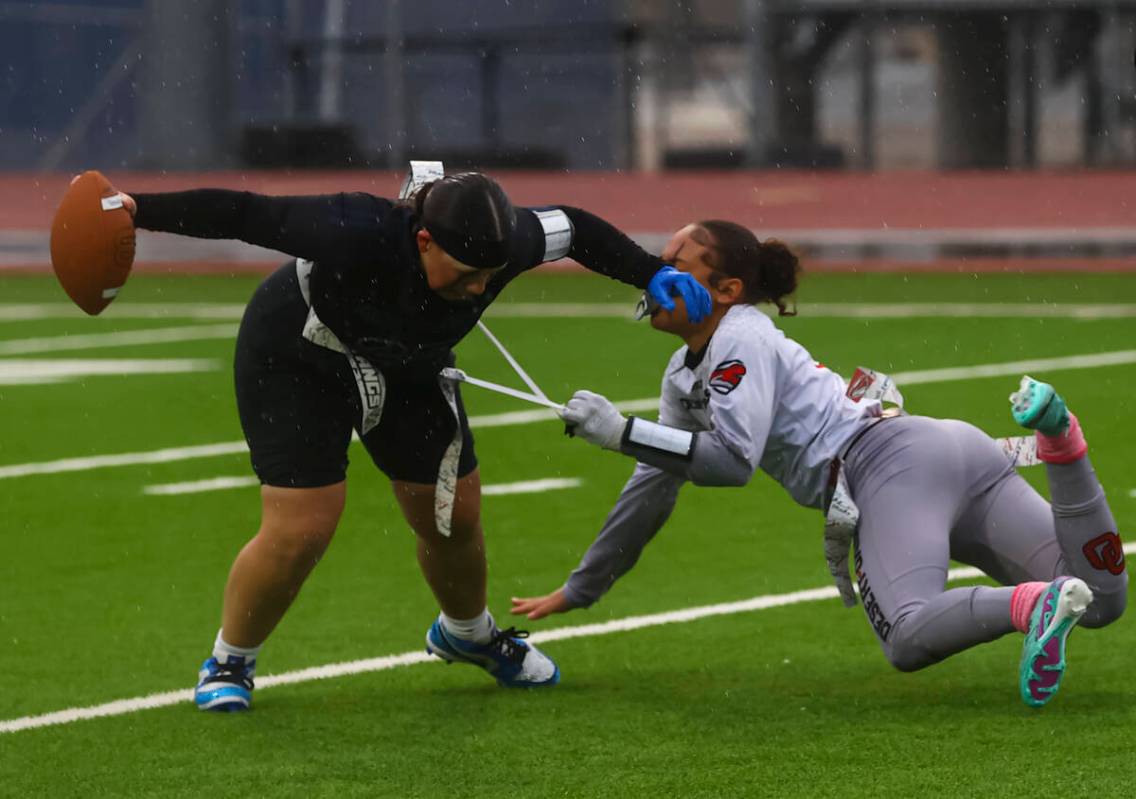 Shadow Ridge quarterback Aubree Davis (22) gets sacked by Desert Oasis' Kaaliyah Robinson (8) d ...