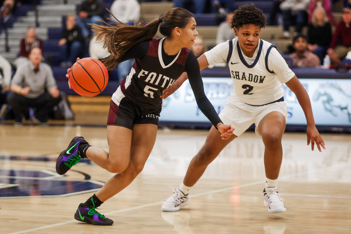 Faith Lutheran point guard Caylyn Young (5) dribbles the ball as shooting guard Avery Freeman ( ...