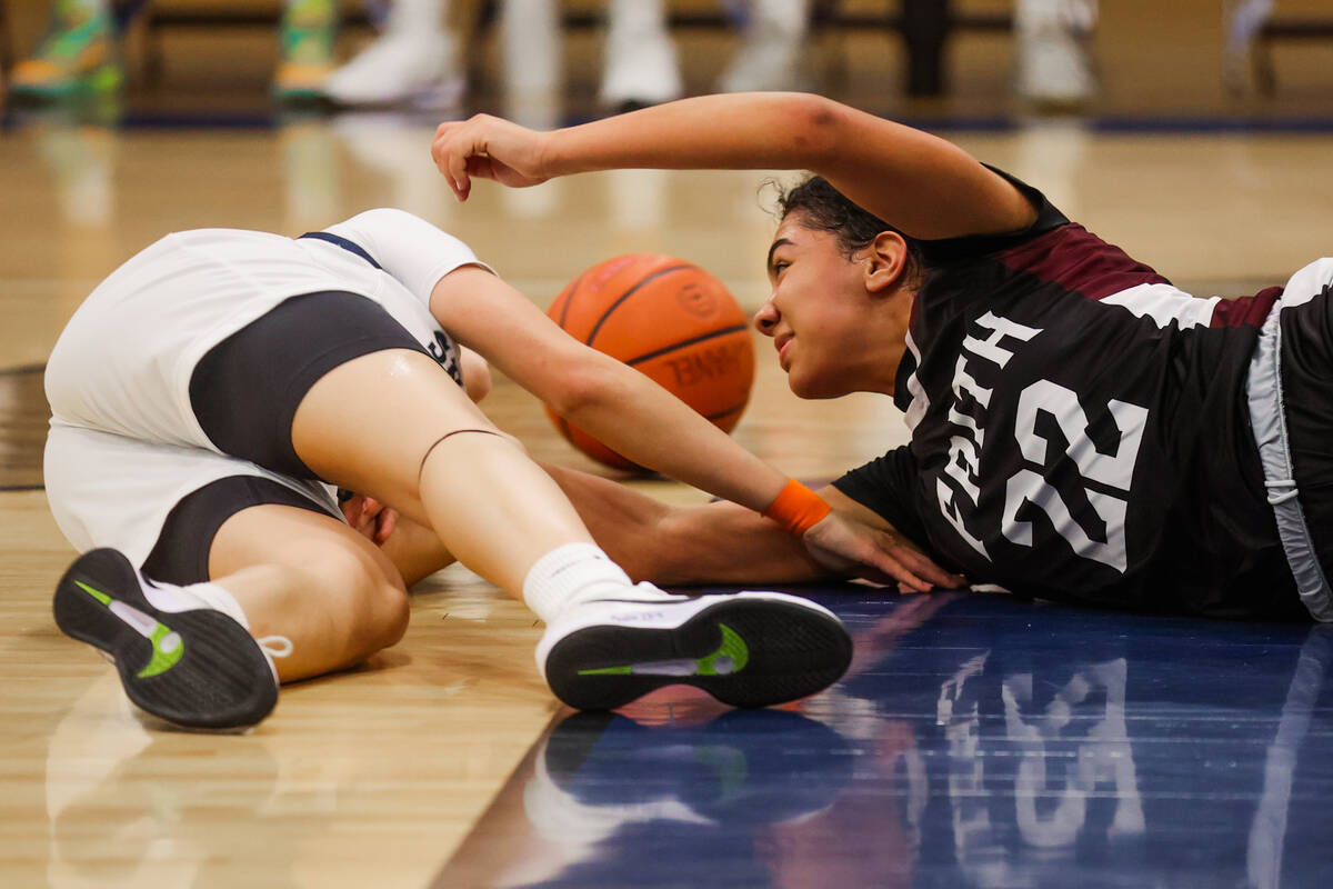 Faith Lutheran forward Khloe Pitts (22) gets into a scuffle for the ball during a 5A girls stat ...