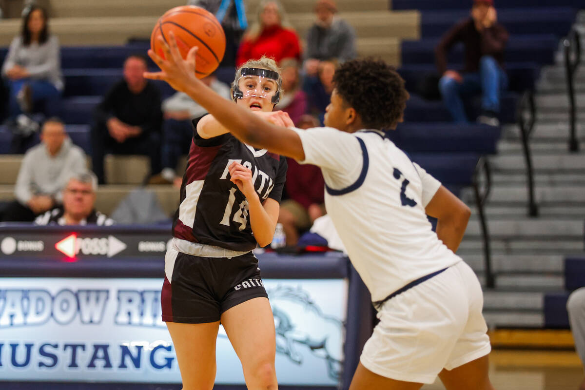 Faith Lutheran guard Kloe Abdalla (14) tosses the ball off to a teammate during a 5A girls stat ...