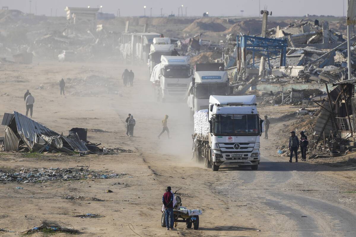 Trucks carrying humanitarian aid enter the Gaza Strip from Egypt in the southern Gaza town of R ...
