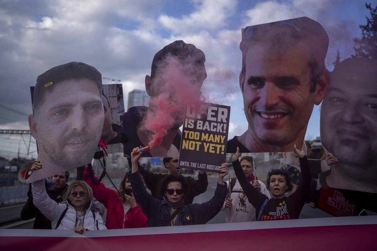 Relatives and supporters of Israelis held hostage in the Gaza Strip, hold photos depicting thei ...