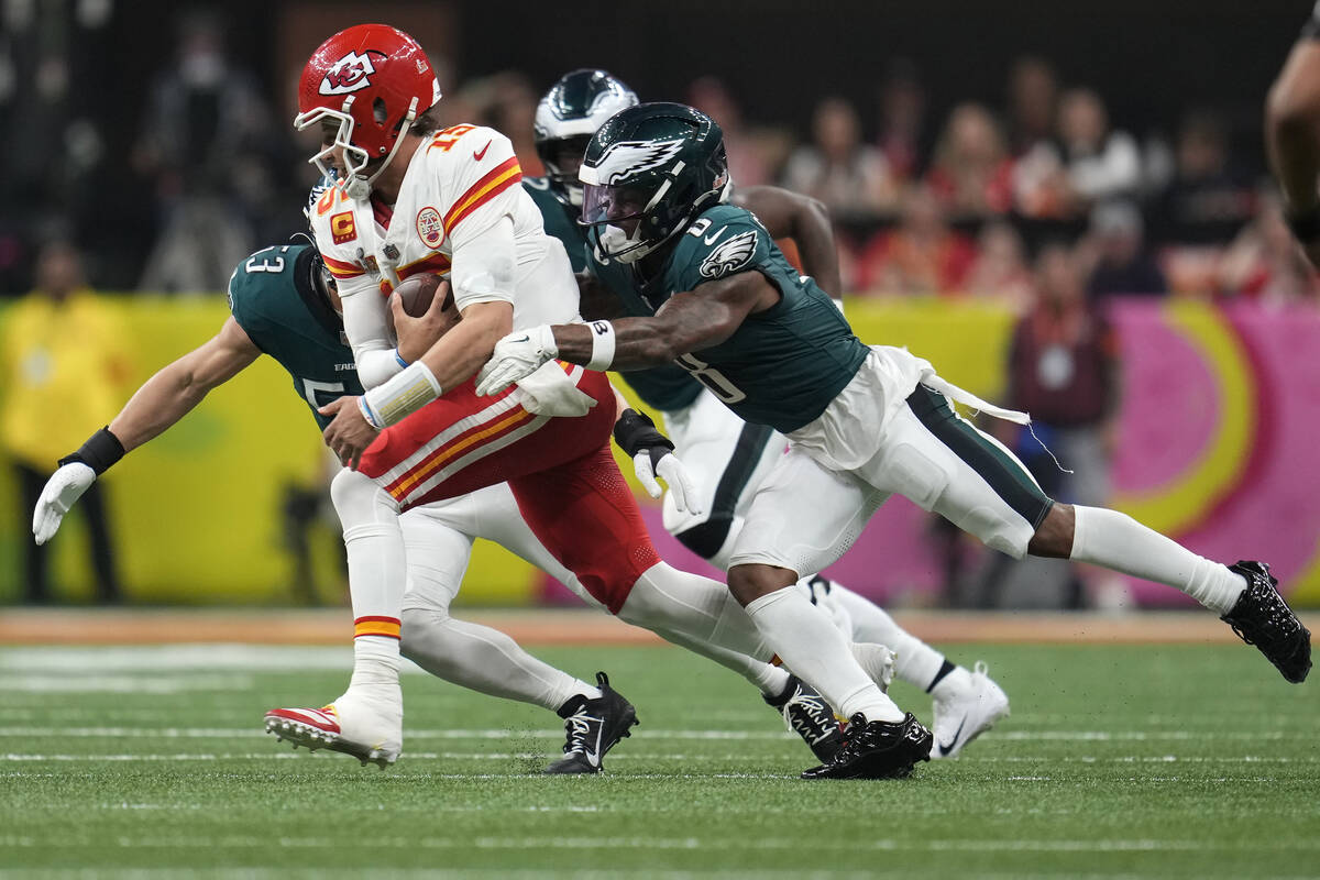 Kansas City Chiefs quarterback Patrick Mahomes (15) is tackled by Philadelphia Eagles safety C. ...