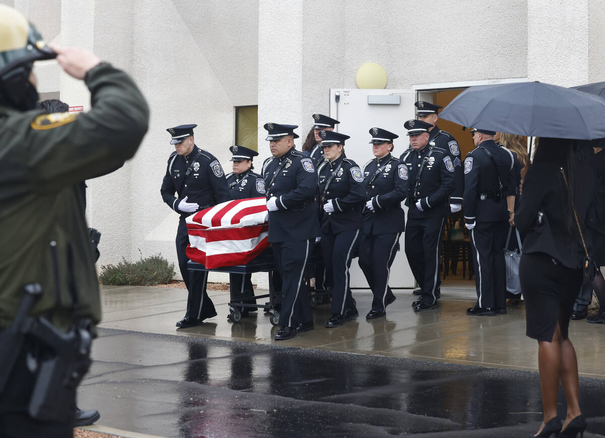 Honor Guard members carry the casket of slain North Las Vegas police officer Jason Roscow, 46, ...